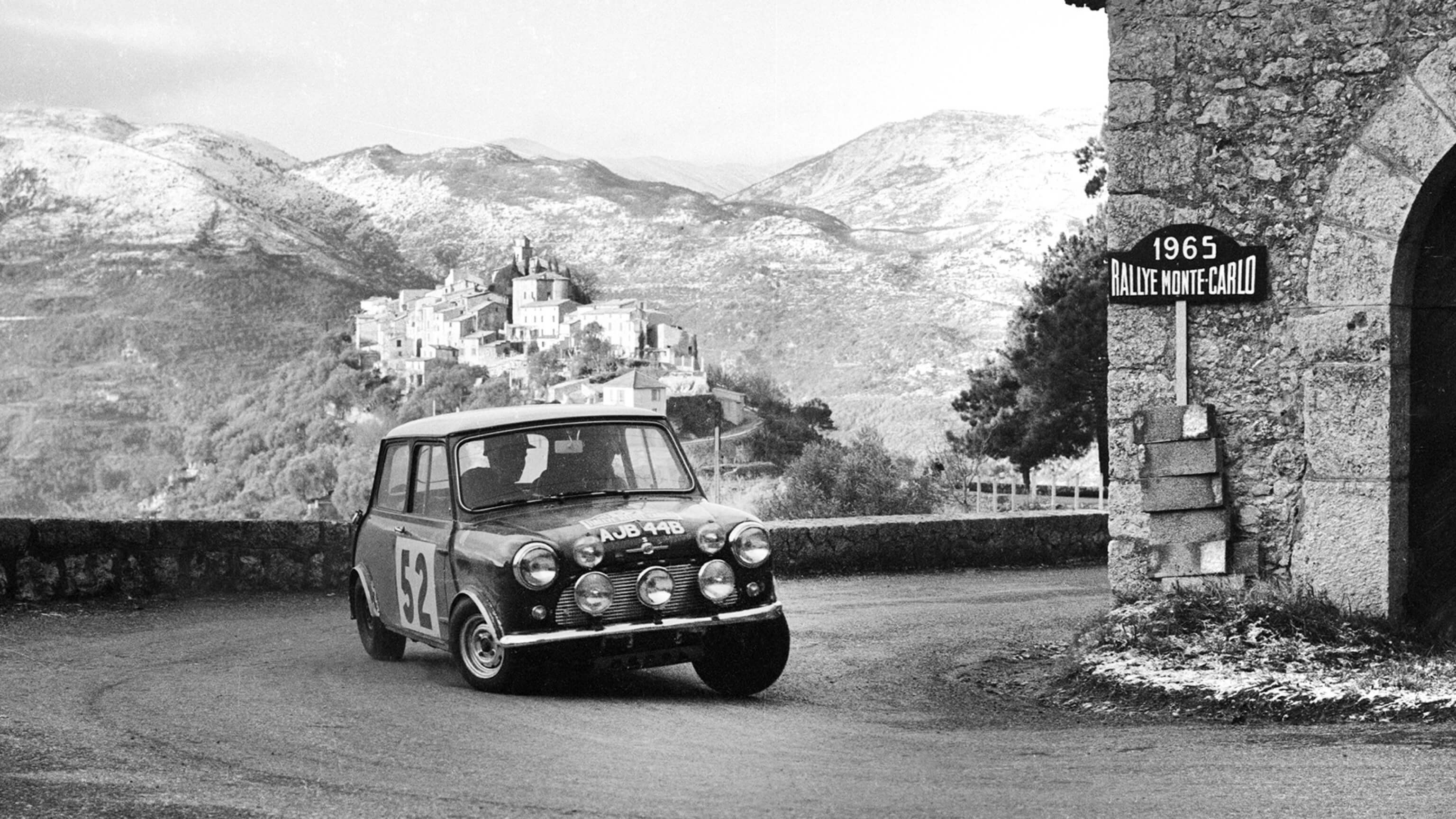 BMC Works Mini Cooper S speeds around a turn at the 1965 Monte Carlo Rally.